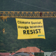 Two environmental activists scale a crane in Wellington and unfurl a banner to welcome Secretary of State Rex Tillerson in New Zealand (Photo courtesy of the New Zealand Green Party)
